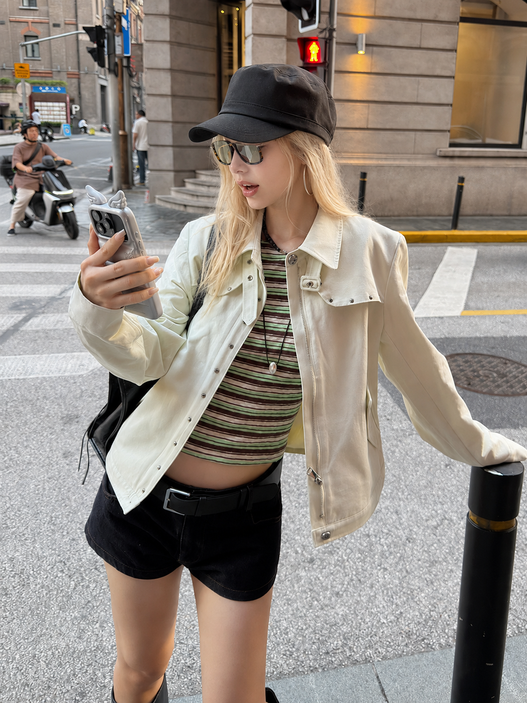 Side sitting view of the Florise Studio Vintage Stud Utility Jacket in Sage Mist highlighting the clean silhouette, silver stud accents, and versatile transitional styling.