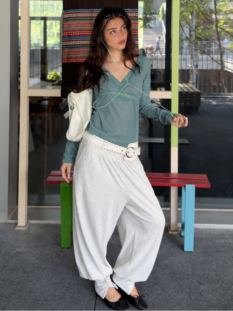 Sage green lace trim V-neck long sleeve top styled with white pants