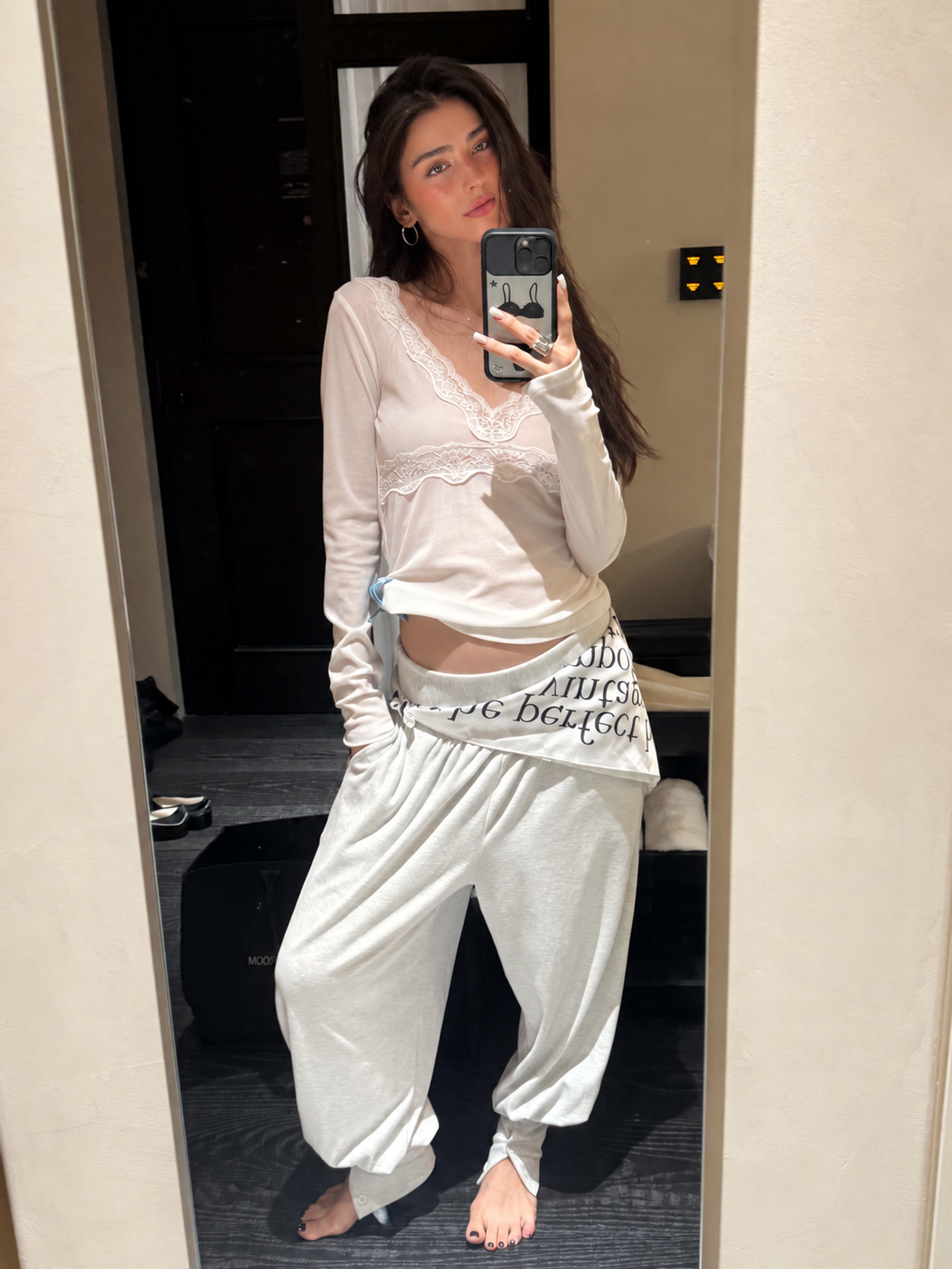 Ivory lace trim V-neck long sleeve top styled with relaxed pants