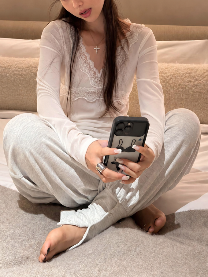 Ivory lace trim long sleeve top in a seated lifestyle view