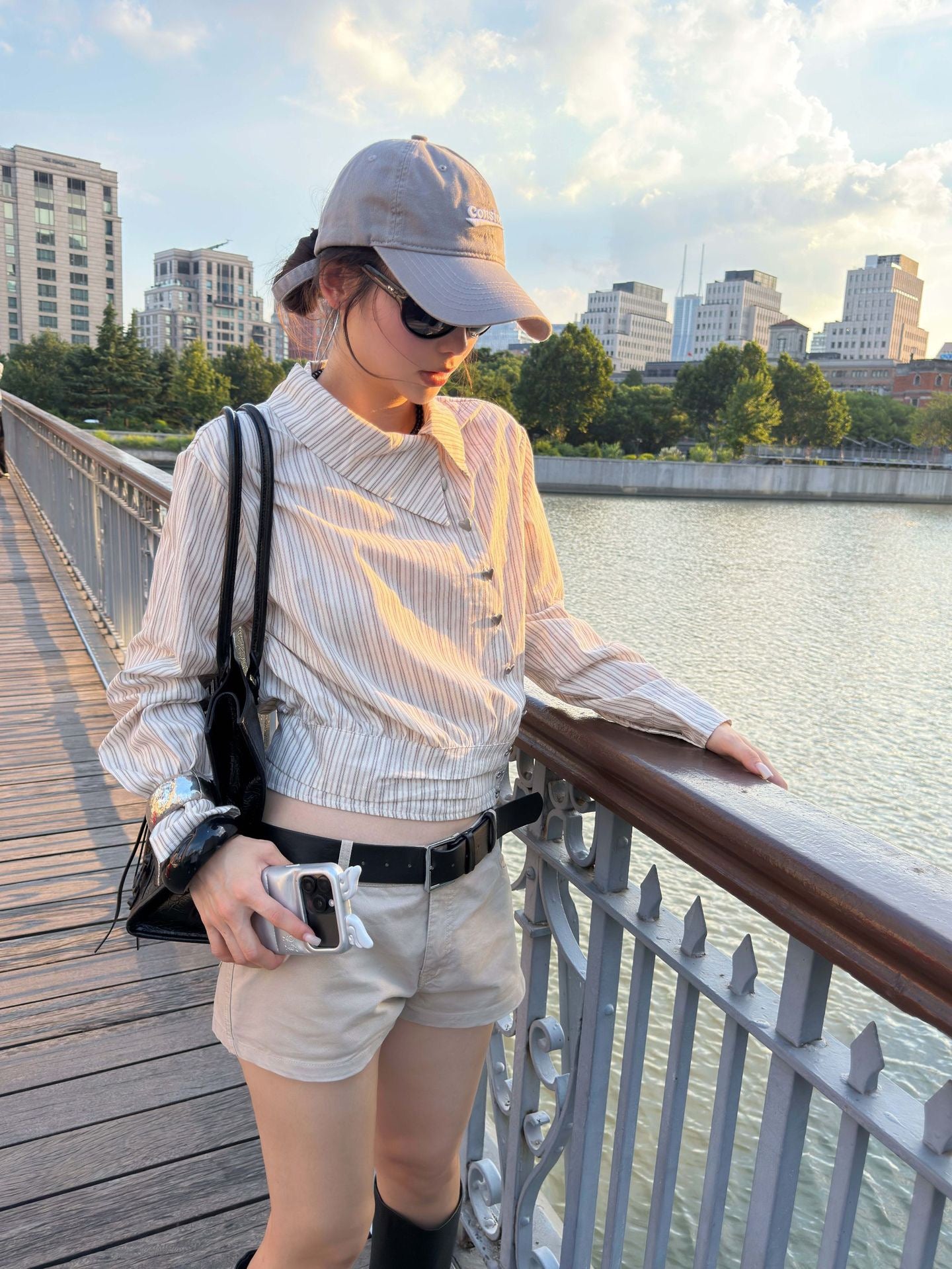 Side view of a women's striped cropped shirt with asymmetrical collar in soft cotton