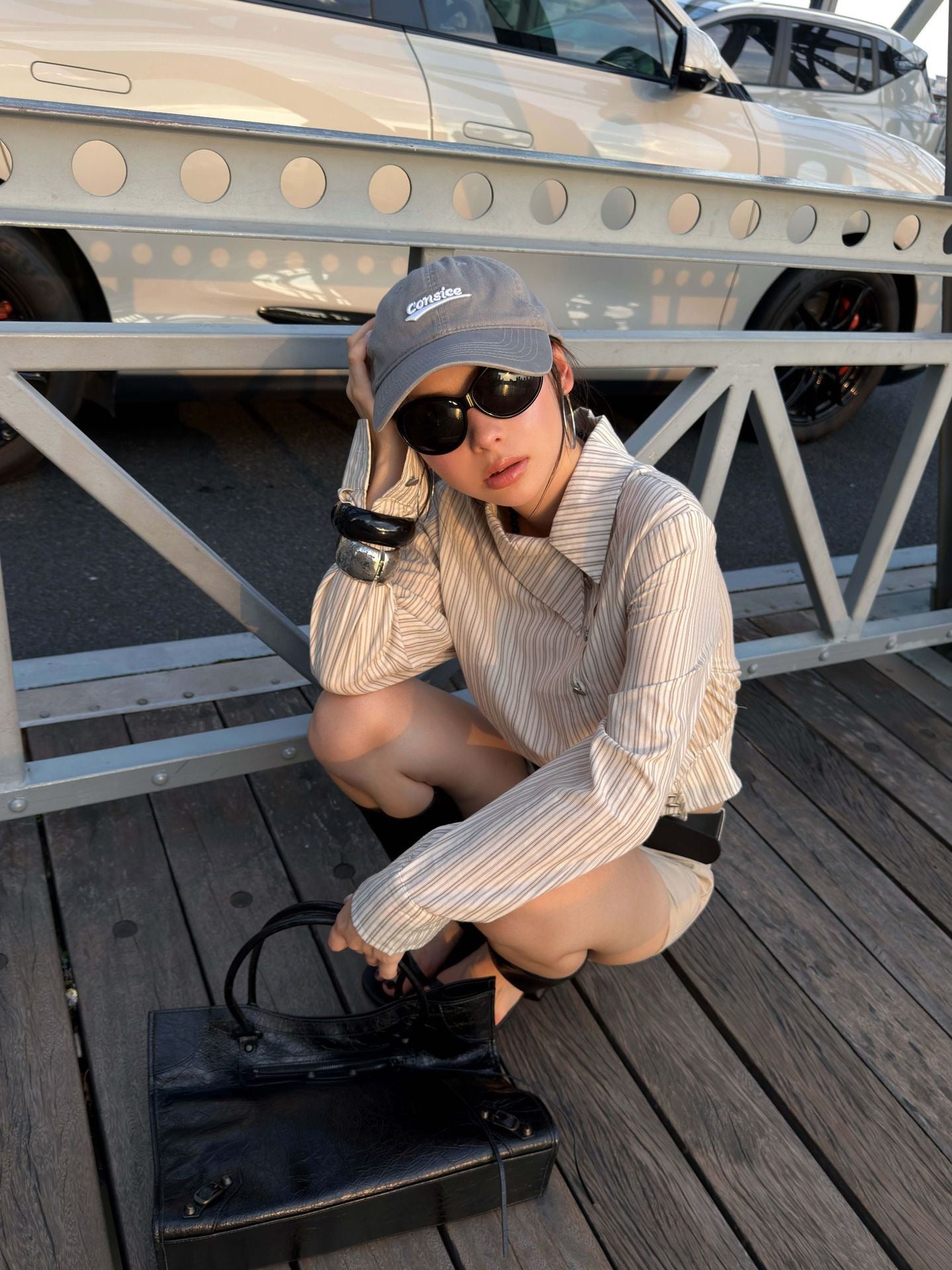 Close-up detail of an asymmetric collar striped shirt with diagonal button front