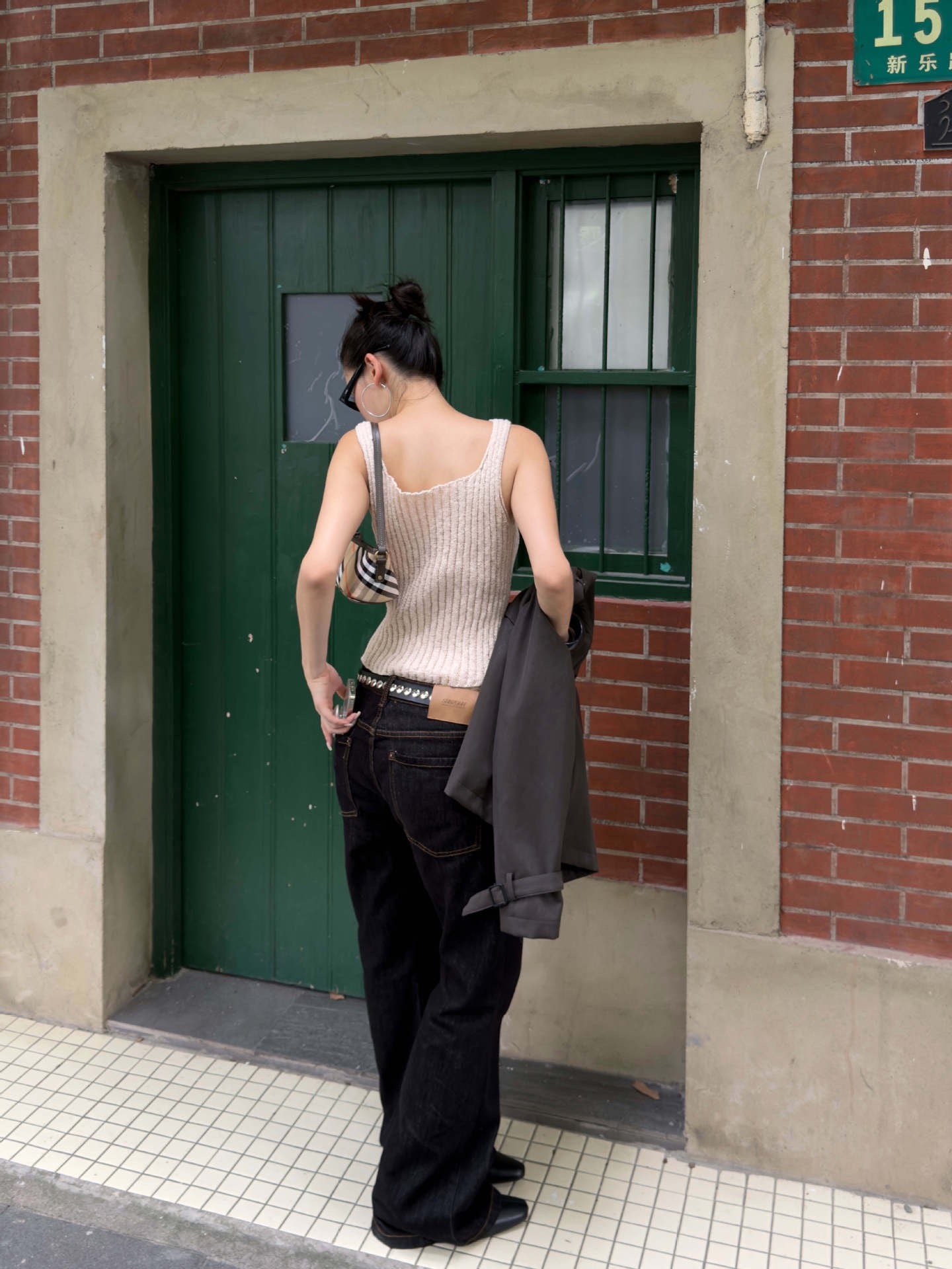 Ivory cream ribbed knit sleeveless tank top featuring fitted shape and soft vertical knit texture