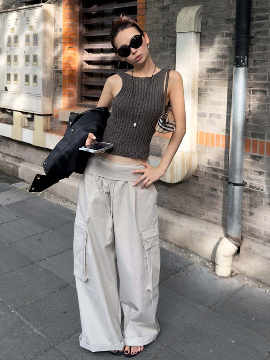 Charcoal gray ribbed knit sleeveless tank top styled with casual streetwear outfit and fitted silhouette