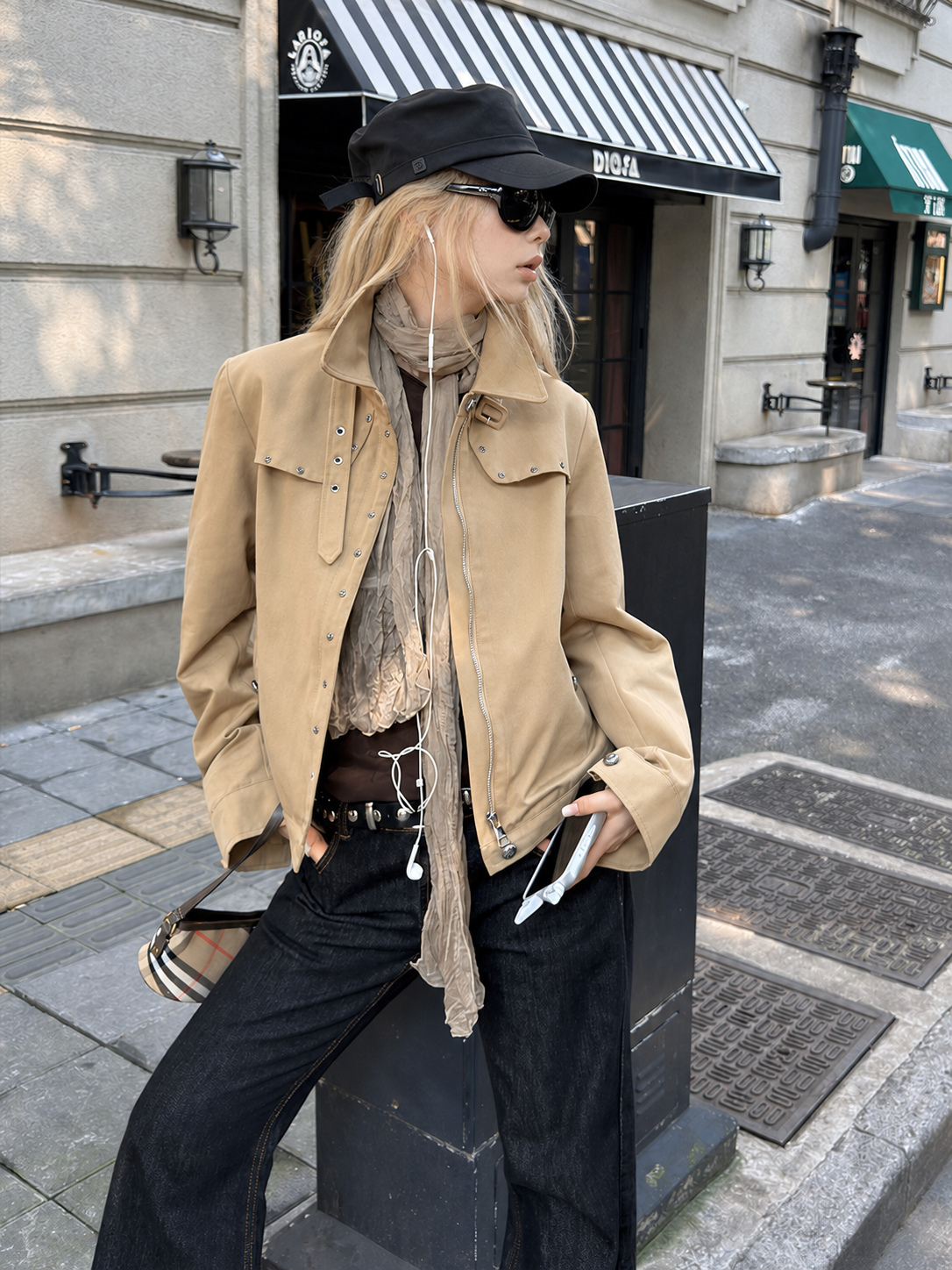 Close-up of the Florise Studio Vintage Stud Utility Jacket in Desert Sand featuring silver stud detailing, concealed front zip closure, pointed collar, and adjustable buckle collar tab.