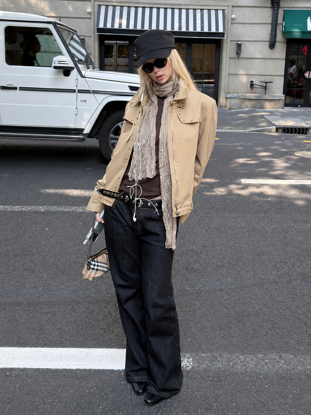 Full-body styling of the Florise Studio Vintage Stud Utility Jacket in Desert Sand paired with relaxed dark denim jeans, highlighting the clean utility silhouette and everyday layering style.