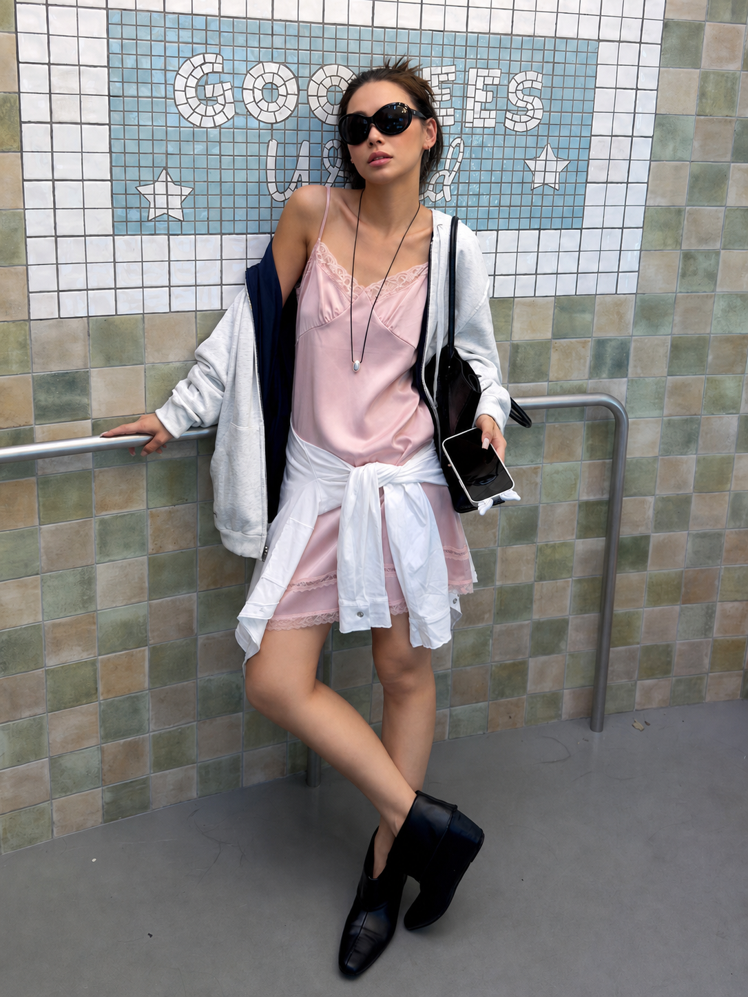 Blush Pink satin lace slip mini dress styled with a white hoodie, black shoulder bag, and black shoes