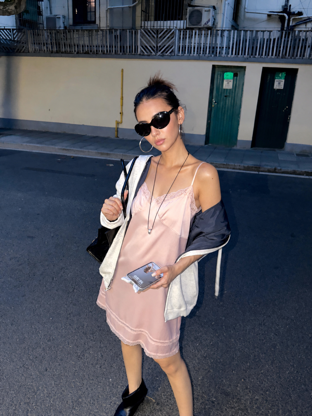 Blush Pink satin lace slip mini dress with adjustable spaghetti straps styled with a white hoodie and black ankle boots