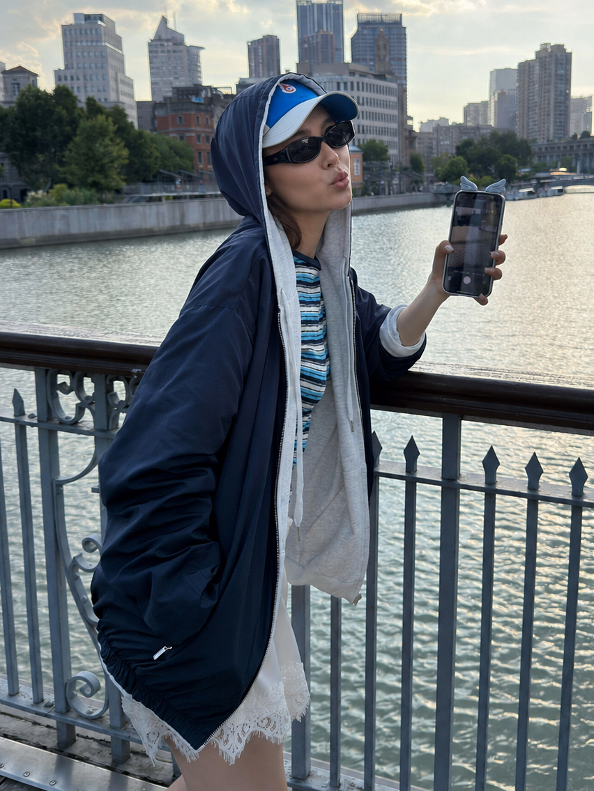 Woman wearing the Florise Studio Reversible Oversized Zip Hoodie Jacket in Midnight Navy, showing the reversible shell side, oversized silhouette, and versatile streetwear styling.