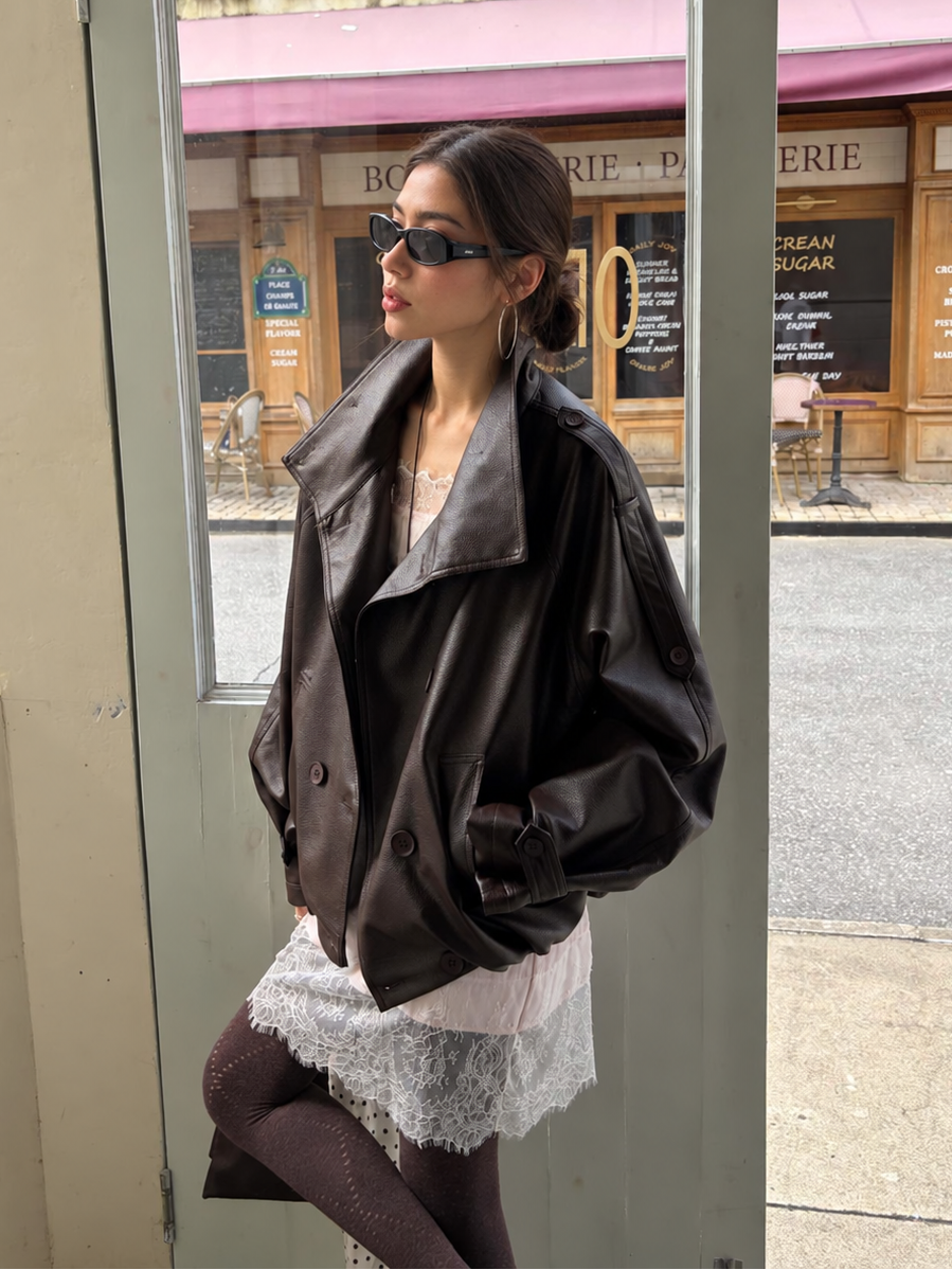 Woman wearing the Avery Oversized Faux Leather Moto Jacket in Espresso Brown with a lace dress, showcasing the oversized moto collar and relaxed fit.