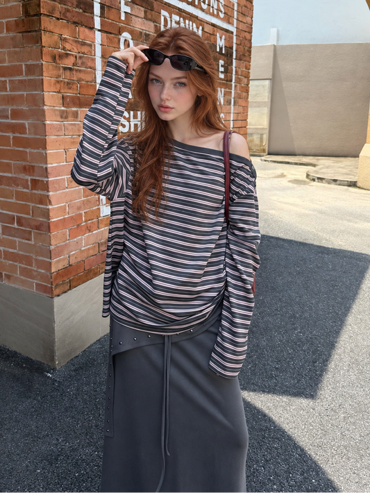 Model wearing Florise Studio Rose Smoke asymmetrical striped drawstring long sleeve top with an off shoulder neckline and side ruching.