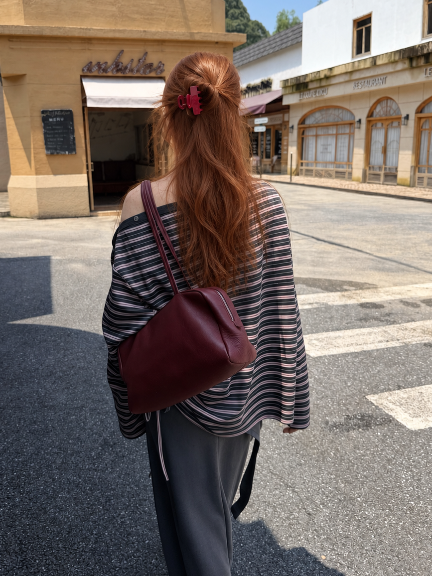 Back view of the Florise Studio Rose Smoke asymmetrical striped top featuring an off shoulder neckline and relaxed oversized fit.