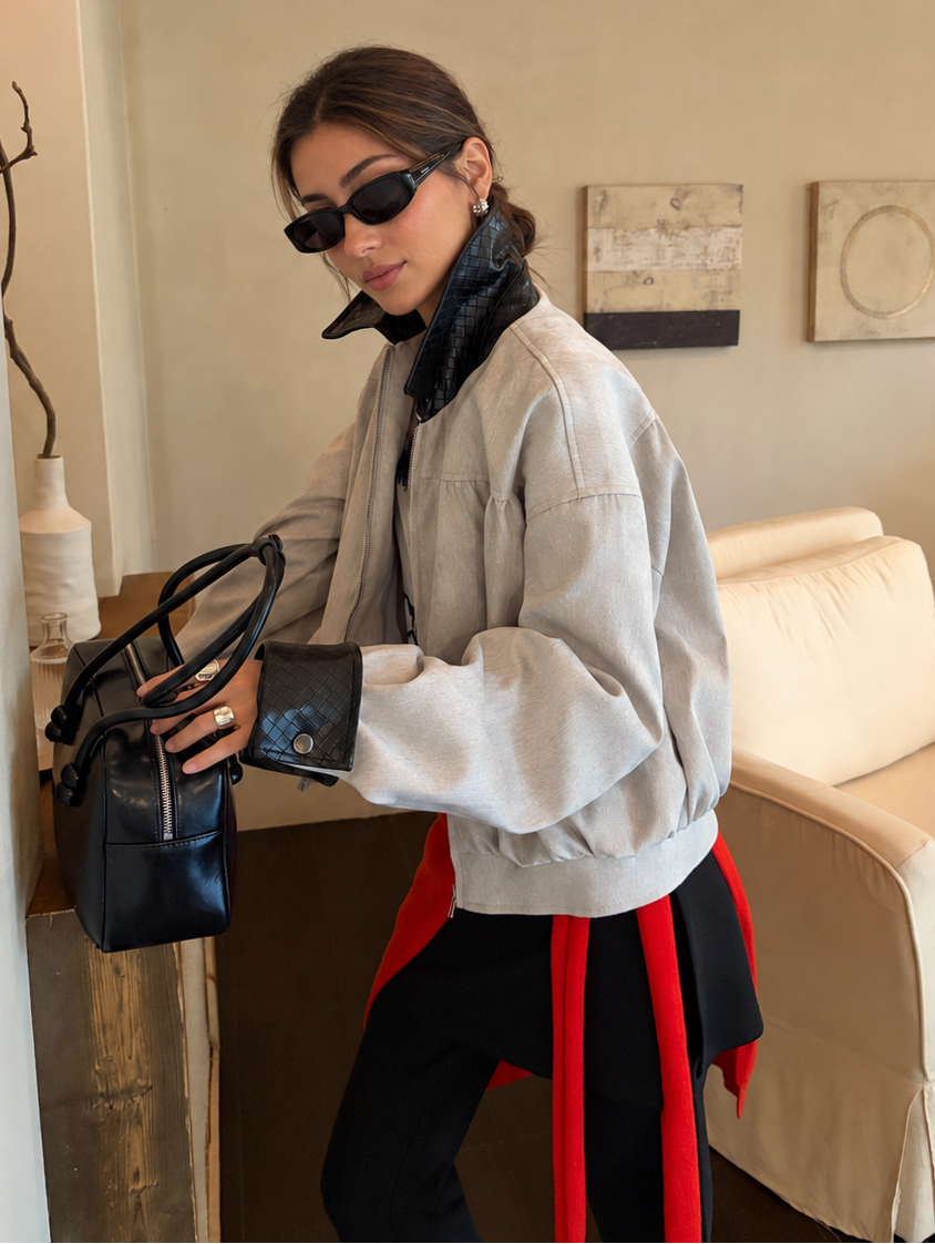 Contrast Collar Relaxed Zip-Up Jacket in light gray with black trim – side view with handbag