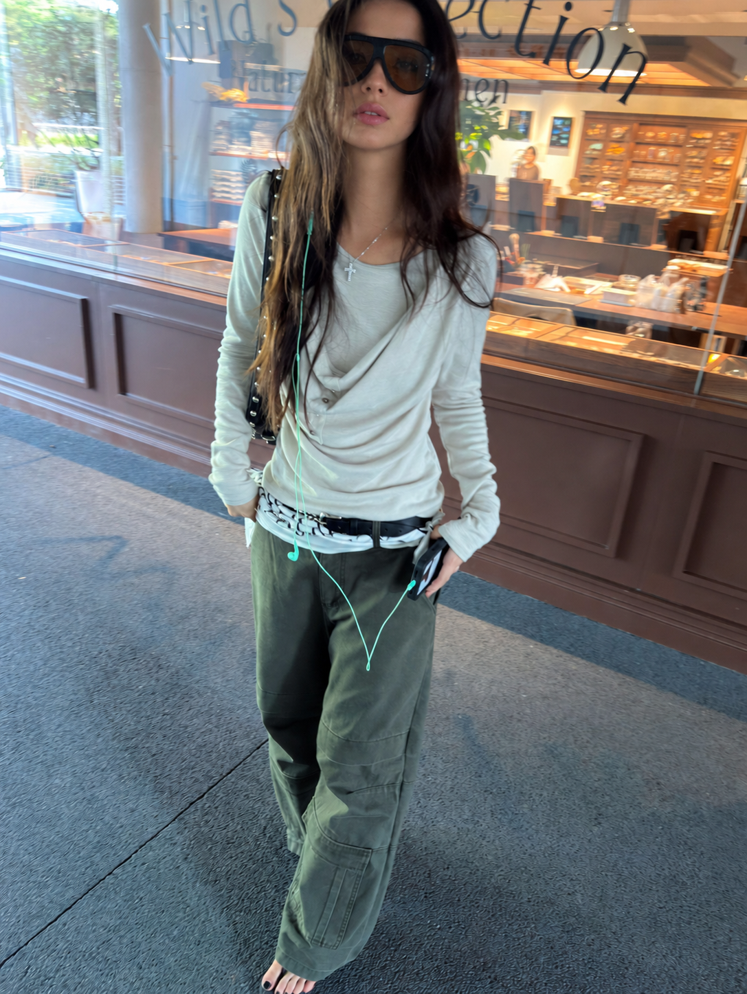 Close view of oatmeal draped button long-sleeve top