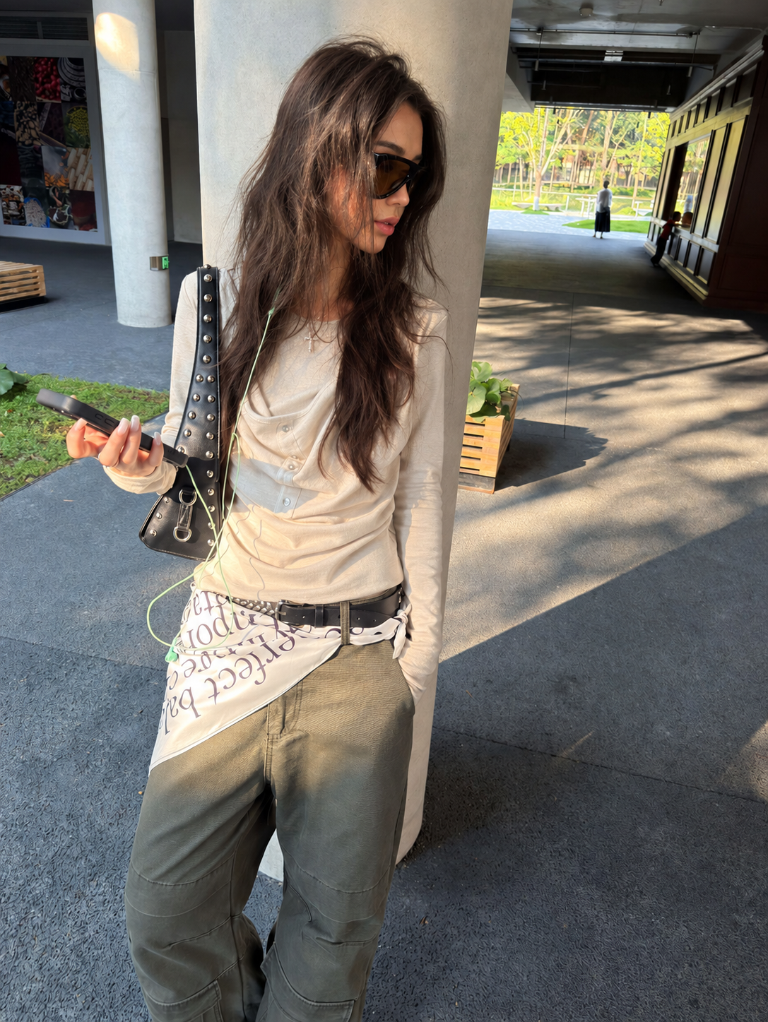 Side view of oatmeal draped button long-sleeve top