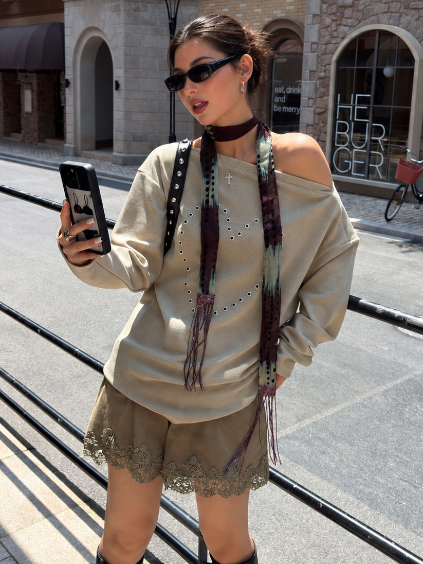 Sage green floral lace-trim shorts in a close front view