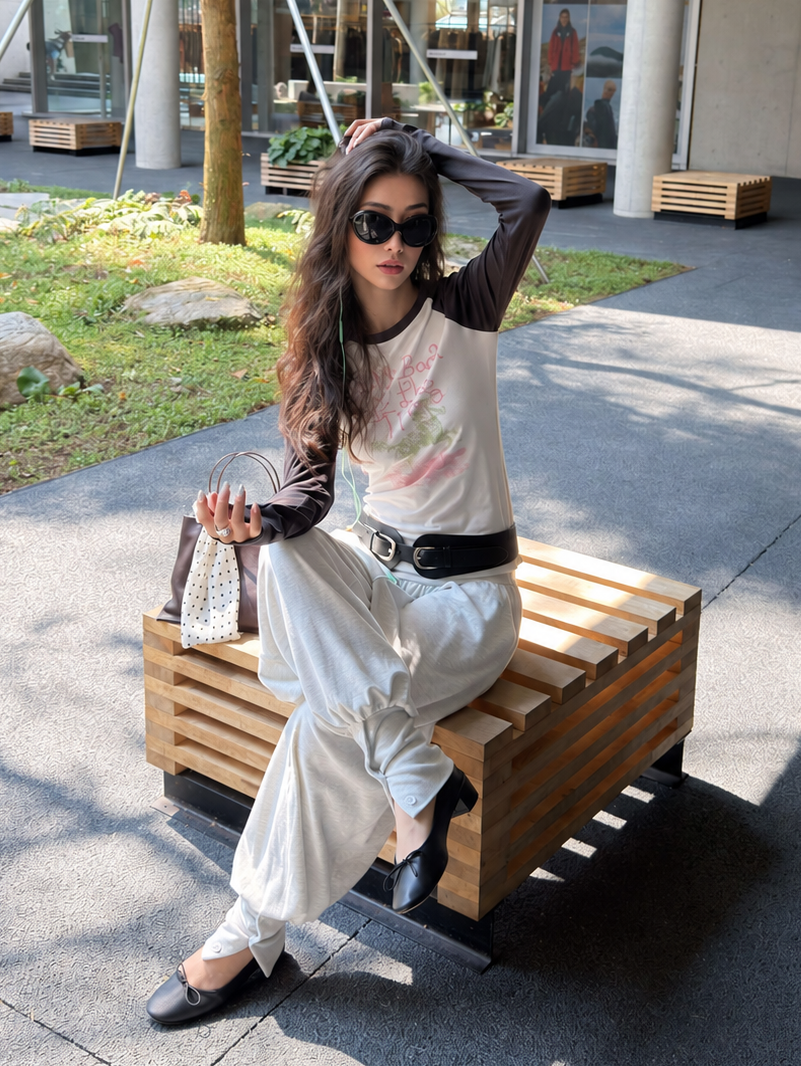 Look Back graphic raglan top in white and charcoal – seated styling view
