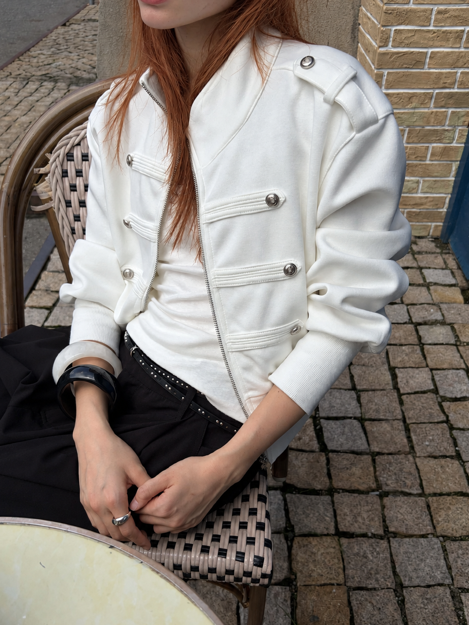 Close-up of the Florise Studio Military Cropped Jacket in Ivory White highlighting decorative metal buttons, structured tailoring, and premium fabric texture.