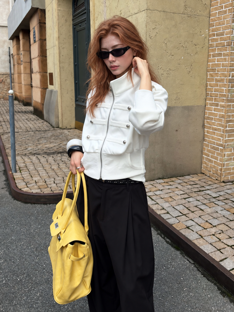 Model wearing the Florise Studio Military Cropped Jacket in Ivory White with a structured stand collar and polished silver button details for a modern city look.