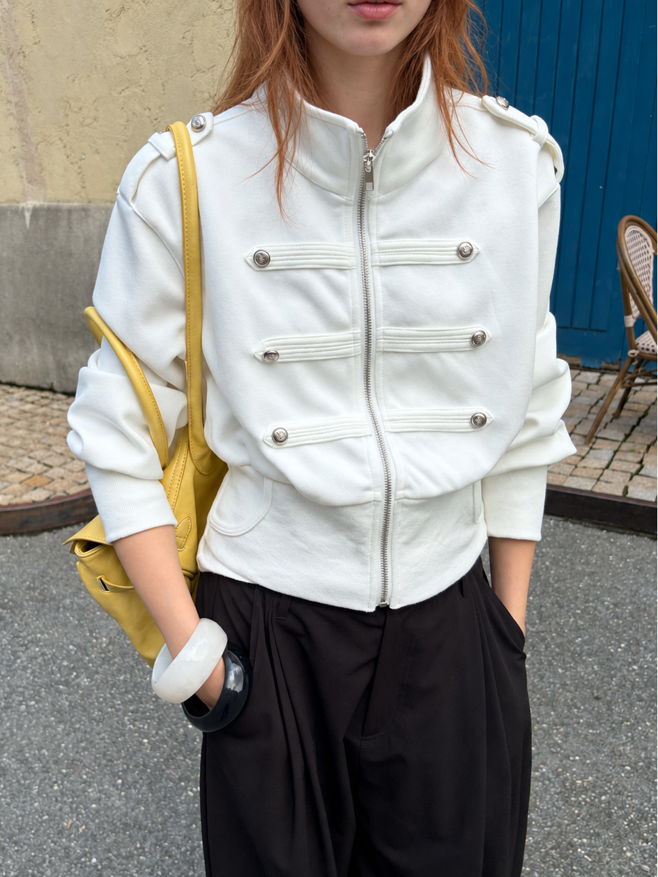 Close-up of the Florise Studio Military Cropped Jacket in Ivory White showcasing the stand collar, silver hardware, and structured cropped construction.