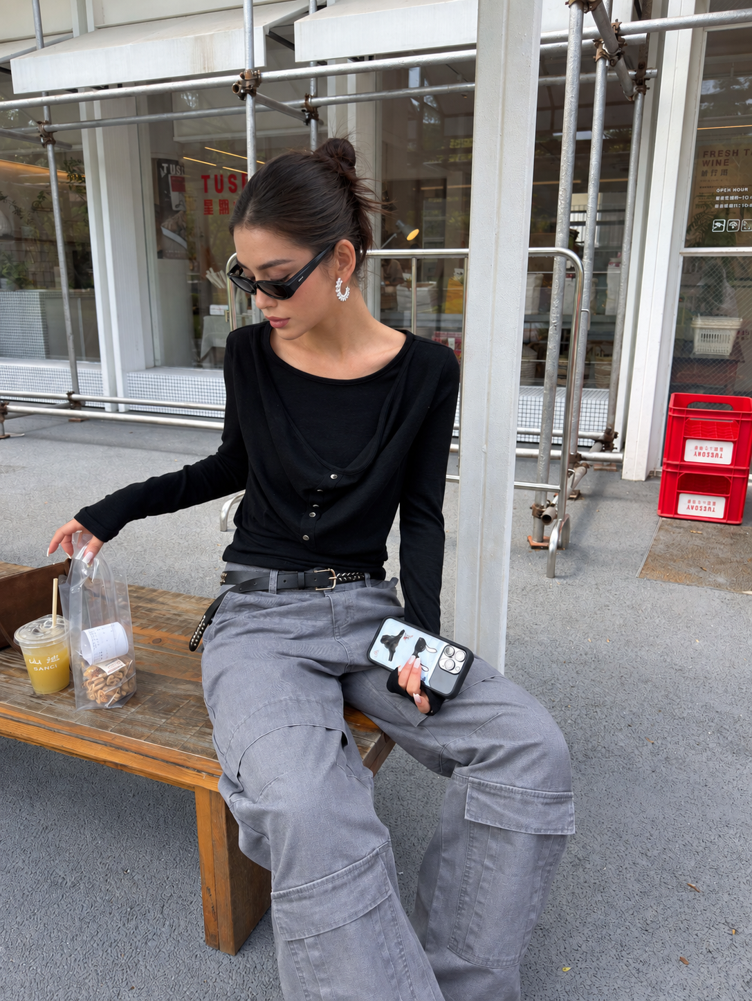 Washed gray cargo pants in a seated styling view