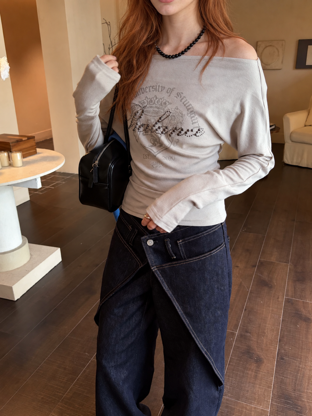 Close-up of the asymmetric wrap waistband and wide leg silhouette in Midnight Indigo denim.