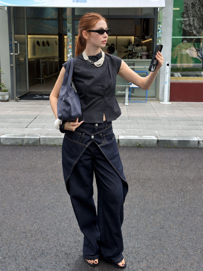 Street style outfit featuring Midnight Indigo Asymmetric Wrap Wide Leg Jeans with a structured vest.
