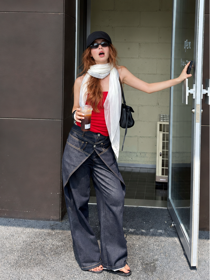 Model wearing Midnight Indigo Asymmetric Wrap Wide Leg Jeans with a red tube top, black cap and lightweight scarf.