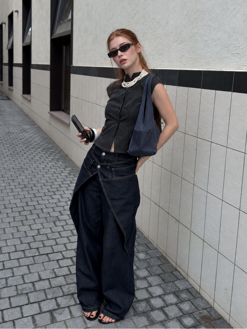Street style look featuring Midnight Indigo Asymmetric Wrap Wide Leg Jeans paired with a sleeveless textured vest.