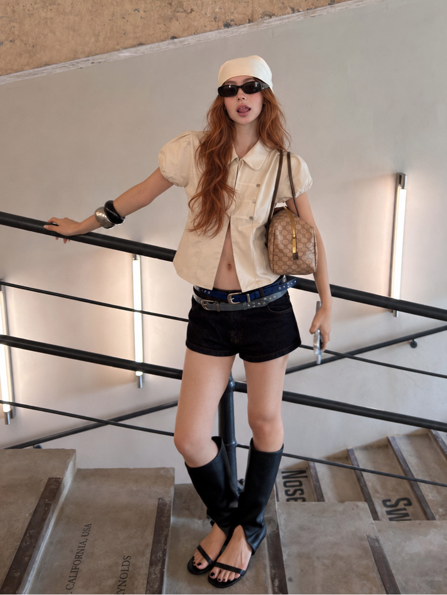 Vintage Military Puff Sleeve Shirt in Ivory Cream paired with dark denim shorts and knee-high boots.