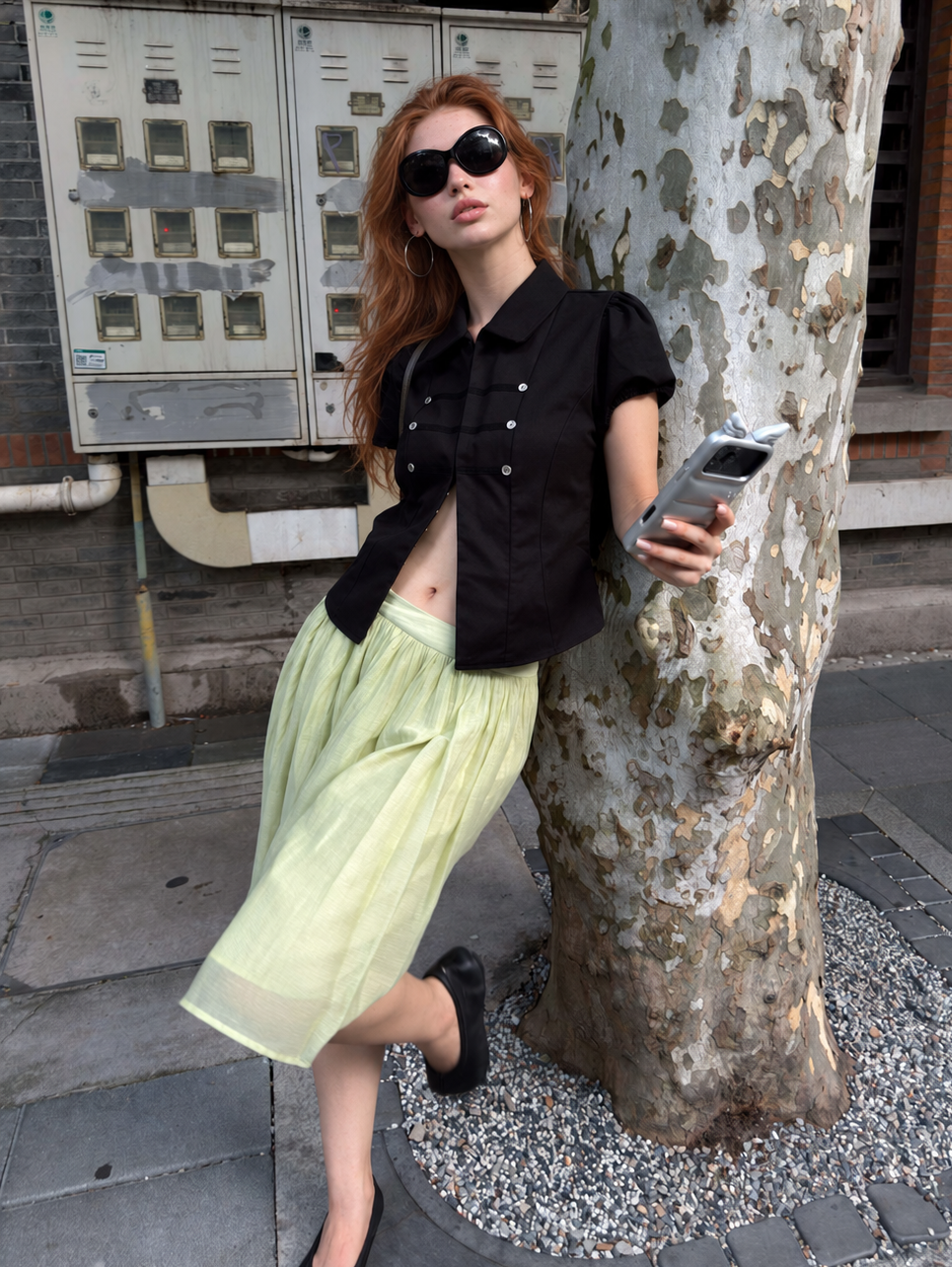 Women's Vintage Military Puff Sleeve Shirt in Midnight Noir styled with a flowing light green skirt for an elegant streetwear outfit.
